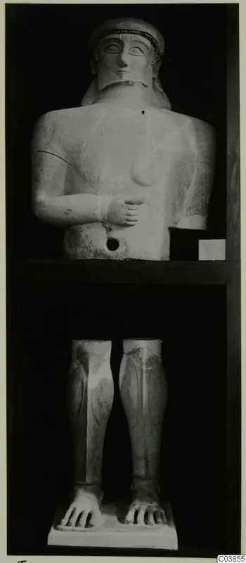 Terracotta statue from Tomassos, shown as an upper body with head and legs with feet on two shelves