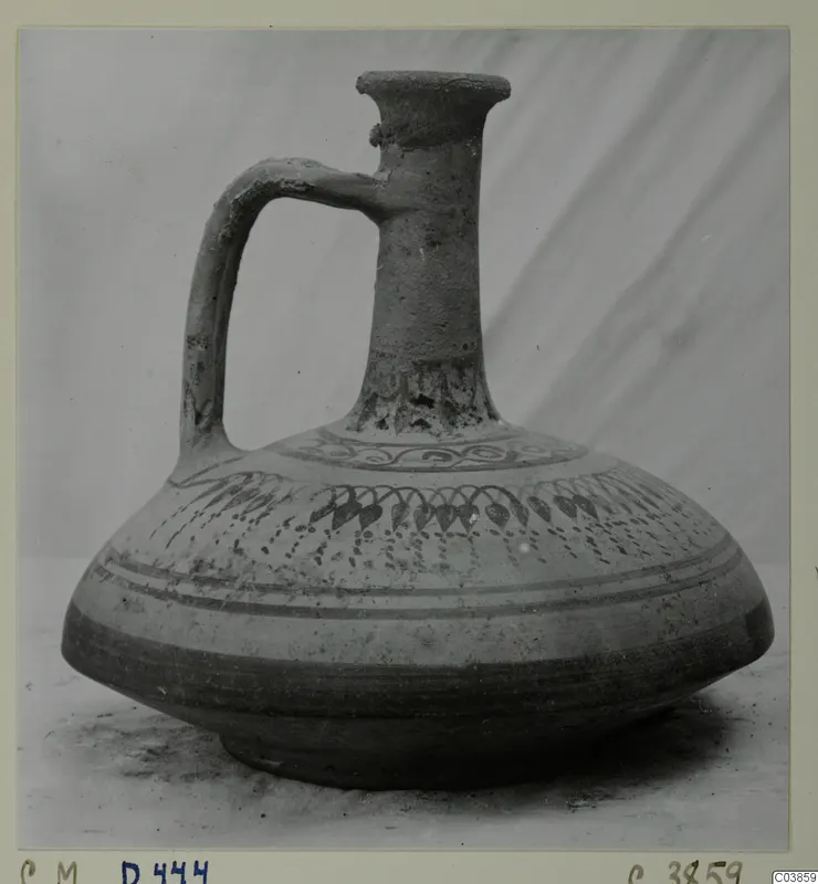 Jug with a single loop handle, flared mouth and dark painted bands on the body