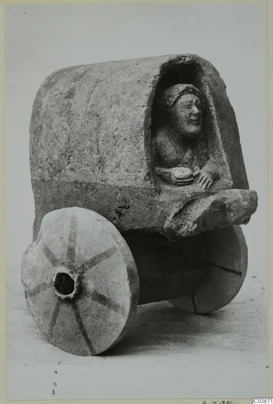 Limestone model cart from Mersinaki with a seated female figure in its covered body