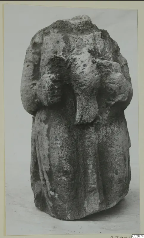 Limestone sculpture of a draped standing figure from Mersinaki, its top broken away