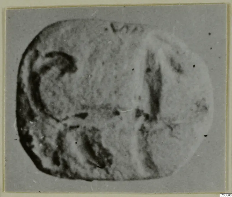Engraved seal or gem with a rounded-rectangular face, photographed against a plain grey ground