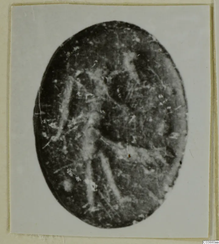 Oval engraved stone seal or gem with a faint standing figure, shown face-on
