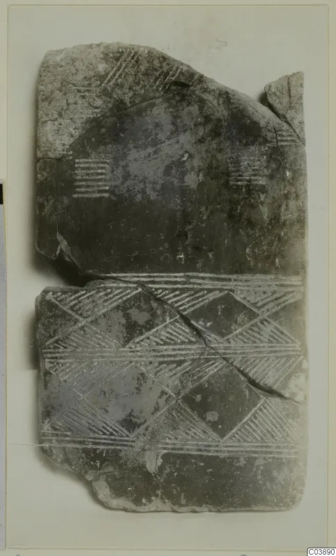 Broken flat fragment with incised chevron and hatched bands, photographed on a mount