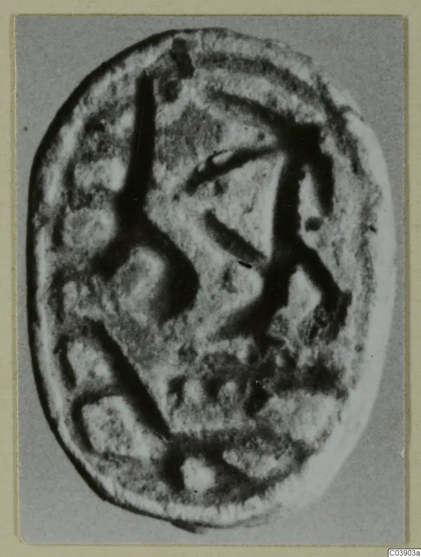 Engraved oval seal from Amathus, photographed face-on against a grey backdrop