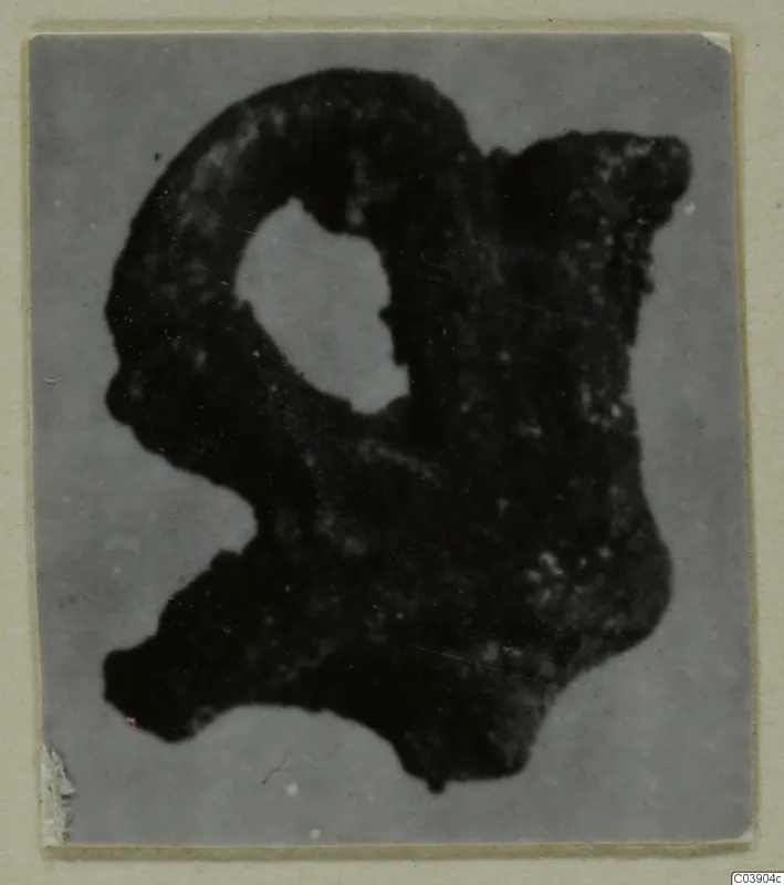 Corroded bronze fragment with a loop, from Amathus.