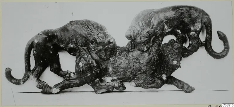 Bronze group of two maned, feline animals attacking a larger animal lying between them