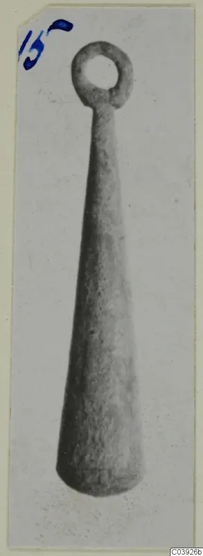 Tapering object with a ring-shaped loop at the top, shown upright on a card mount