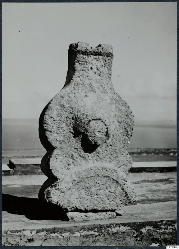Limestone sculpture from Vouni, a weathered upright figure with a rounded face-like boss, standing on a stone base
