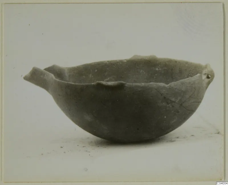 Pottery Red Polished III bowl with a small projecting handle and a rounded body, shown against a pale background.