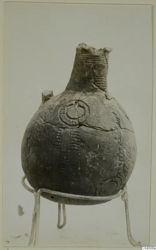 Red Polished III jug from Lapithos, Vrysi tou Barba tombs, shown on a wire stand against a plain background