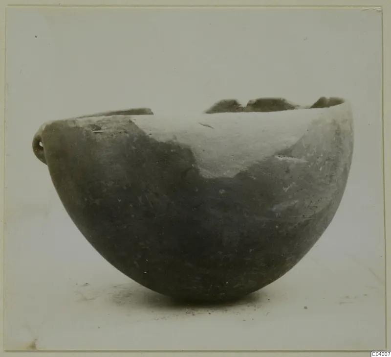 Red Polished III bowl from Lapithos, with a small handle and a broken rim