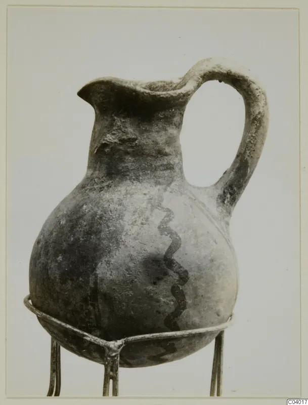 White Painted III-2 jug from Lapithos with a dark wavy line painted down its body