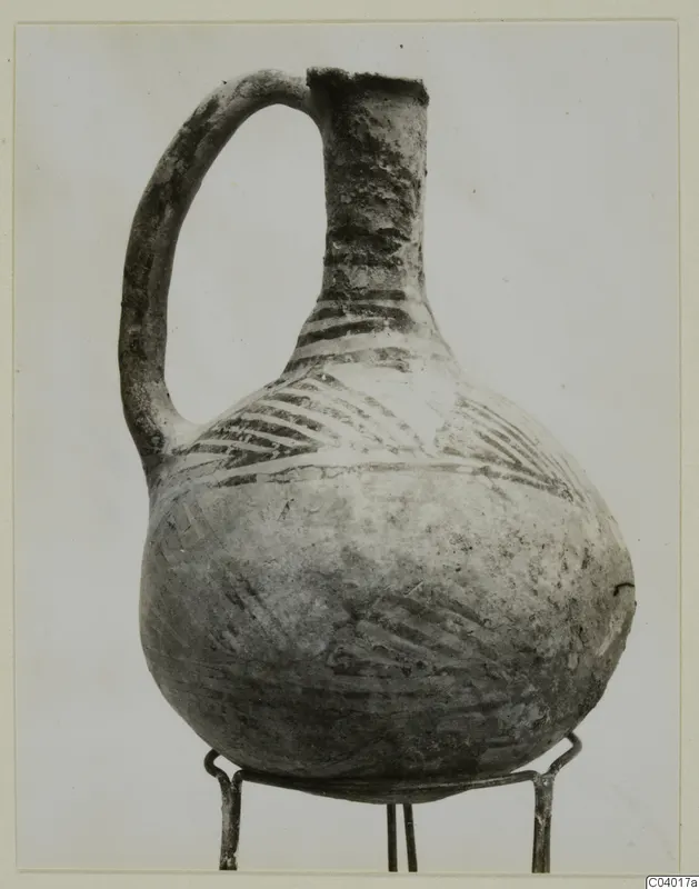 Pottery White Painted III-2 vessel with a loop handle and painted bands, from the Vrysi tou Barba tombs