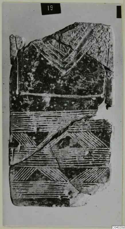 Idols, a broken flat object with incised chevron and hatched band patterns, from Lapithos