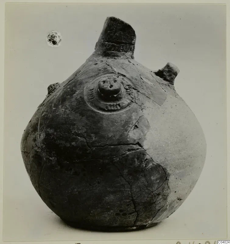 Pottery Red Polished III Amphora from Lapithos, with a tall broken neck, side lugs and a central boss on the shoulder