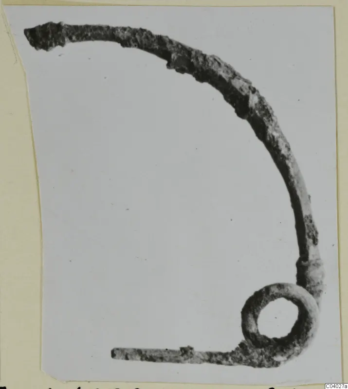 Bronze personal adornment with a curved arm and a loop at one end, from the Kastros tombs at Lapithos