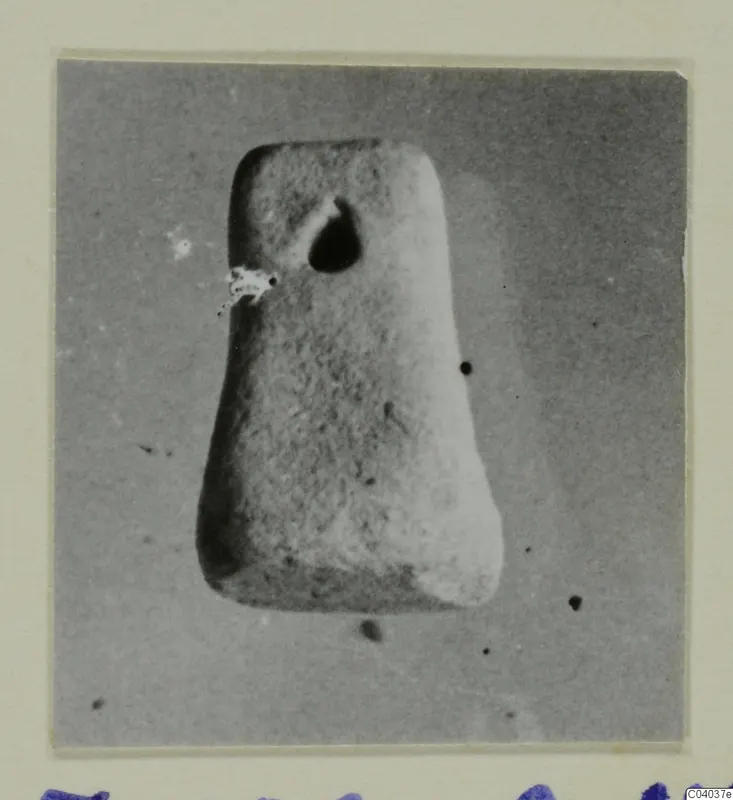 Tapered object with a hole near its top, photographed on a mount, from Idalion