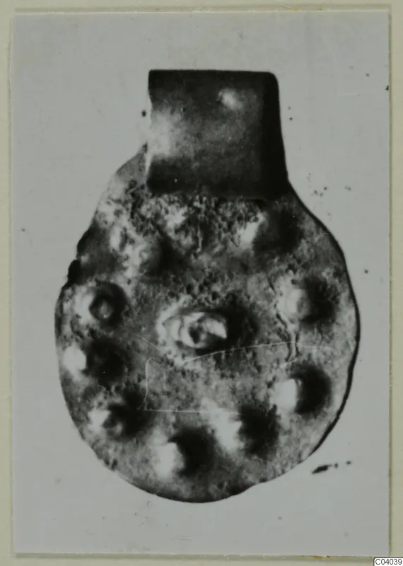 Round pendant with a rectangular loop at the top, from Idalion