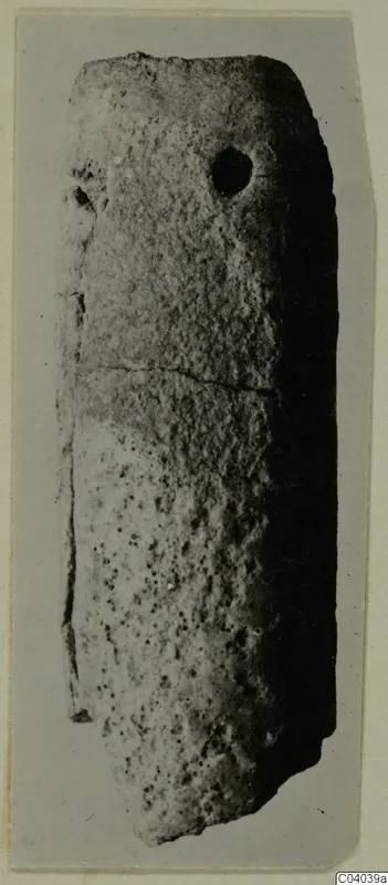Elongated stone pendant with a hole near its upper end, from Idalion.