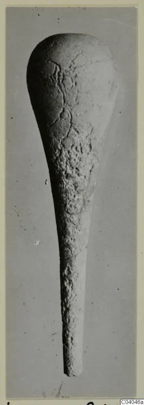 Bone object with a rounded head tapering to a narrow shaft, from Idalion, photographed on a mount