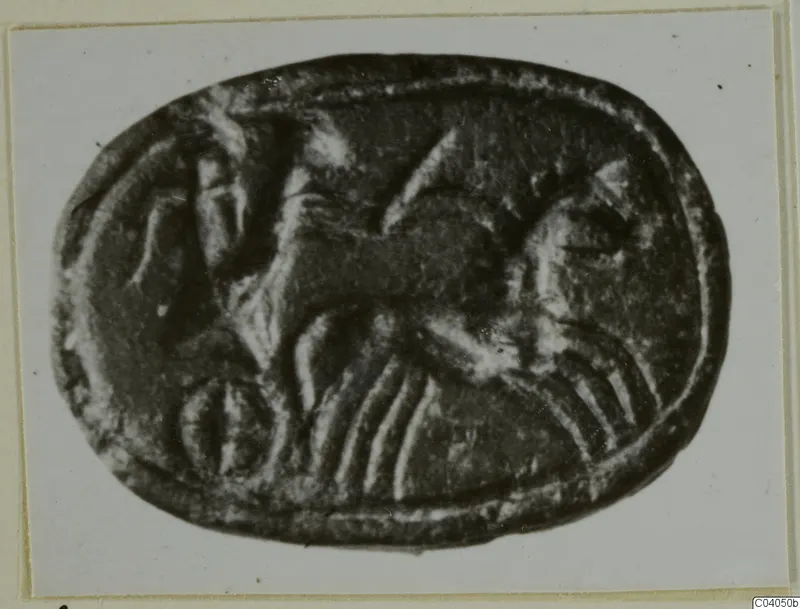Oval stone seal with an engraved animal figure, shown in a photograph on a card mount
