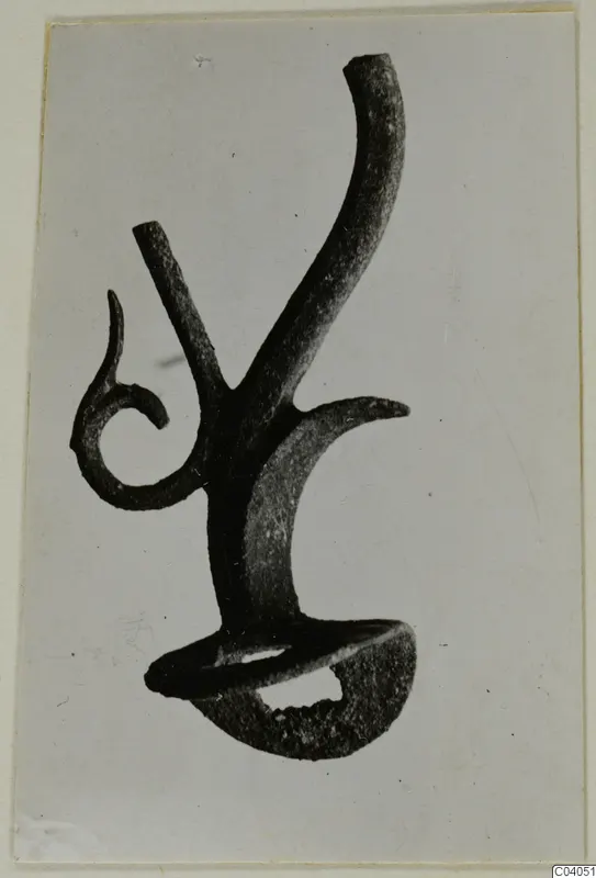 Bronze mounting fragment from Idalion with a curled spiral arm and a tall curved arm
