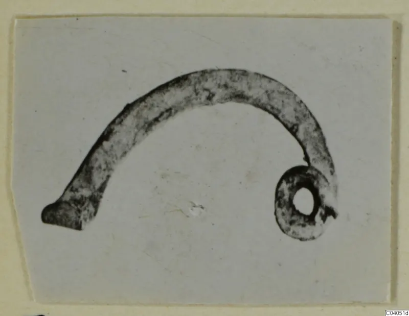 Curved bronze object with a coiled ring at one end, personal adornment from Idalion