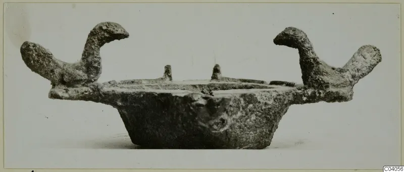 Metal lamp from Idalion with two upturned handles and two small pins on the rim, side view