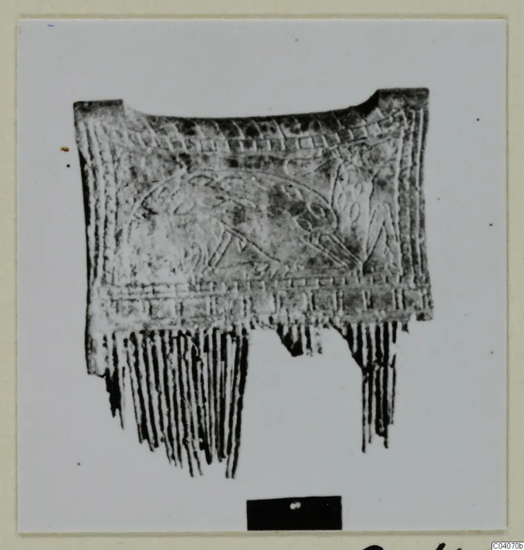 Bone object from Enkomi with incised bands and a central panel, and long narrow teeth along its lower edge