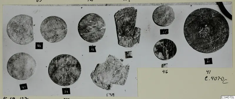 Bone discs and fragments from Enkomi, several with incised concentric rings, each beside a numbered label card