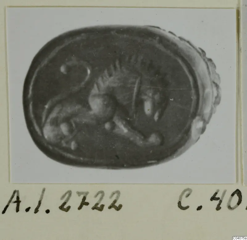 Oval seal with an engraved animal in profile, photographed on a card mount