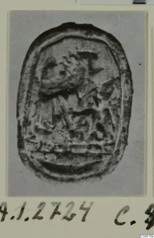 Oval seal-gem from Ayia Irini with a carved design, photographed on a card mount