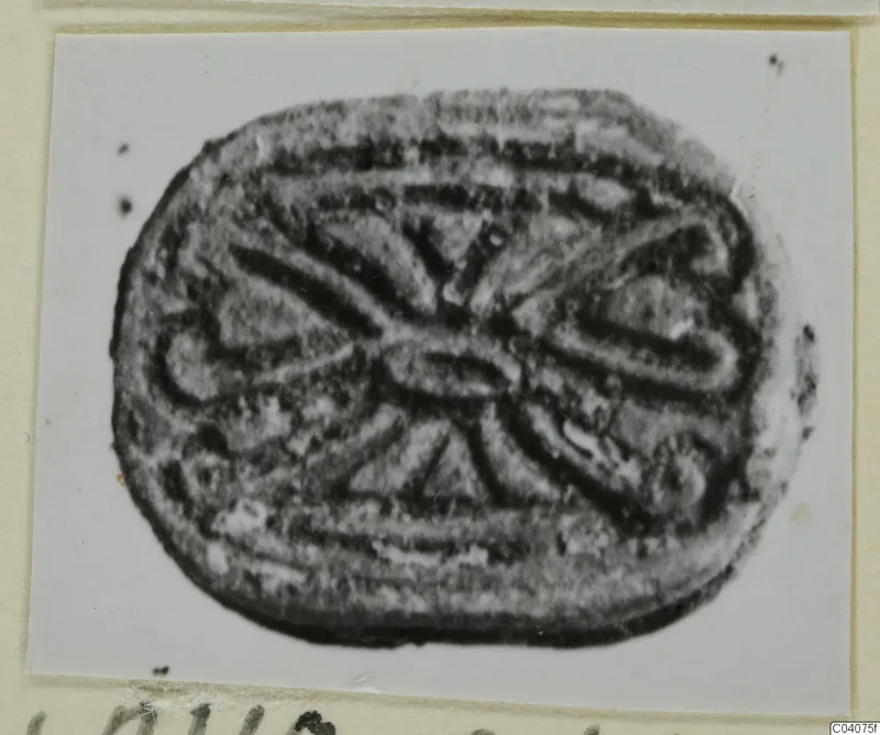 Engraved seal from Ayia Irini, oval in outline, with a symmetrical pattern of curved and radiating lines