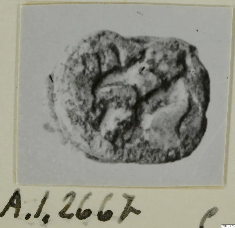 Glyptic from Ayia Irini: an irregular stone object with deep carved grooves across its face