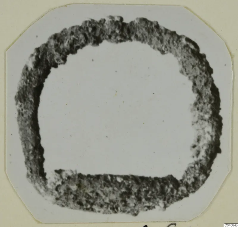 Ring from Marion: a thick, dark, rough-edged ring shape in a photograph mounted on a card