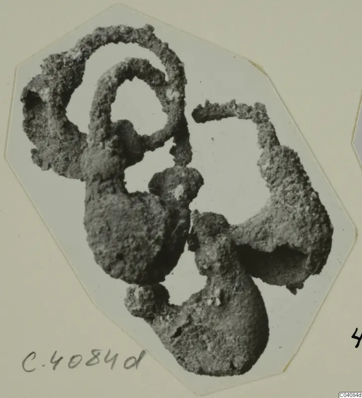 Corroded metal rings from Marion, encrusted and clumped together in a single mass