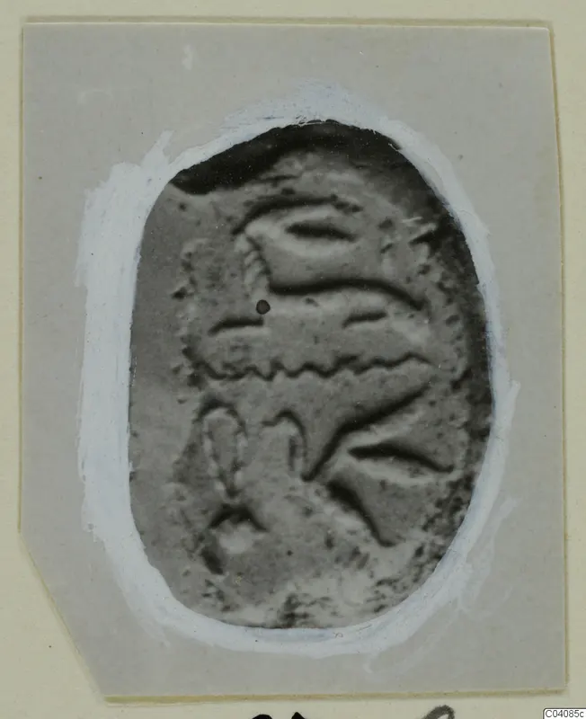 Oval plaque from Marion with a raised pattern of curved bands and a small hole near the upper left.