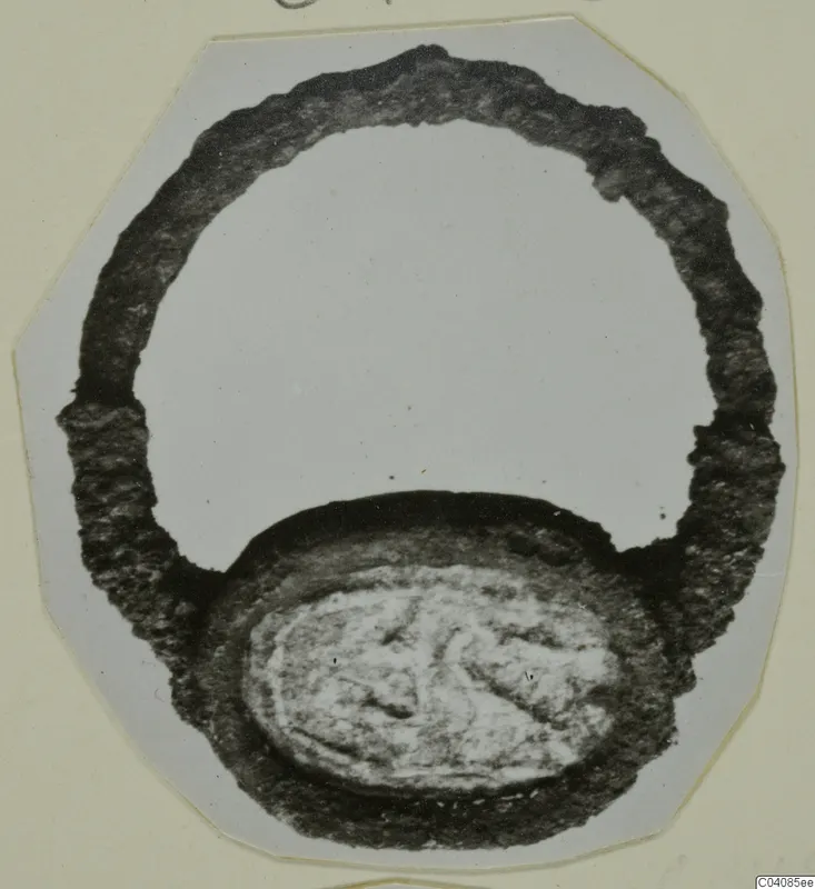 Finger ring with an oval bezel engraved with a figure, from Marion, photographed on a mounted card.