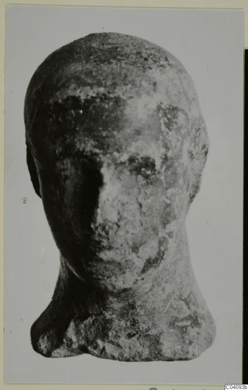 Terracotta head of a small figure, worn, seen from the front