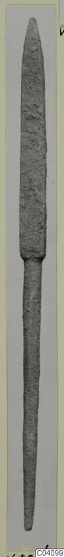 Long slender metal weapon with a pointed blade and narrow tang, photographed upright on a pale card mount.