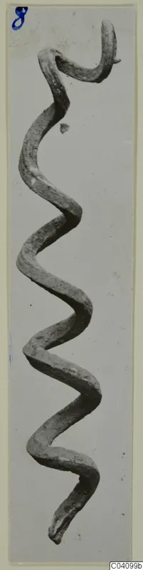 Corroded bronze rod bent into a zigzag with a hooked upper end, from Vouni