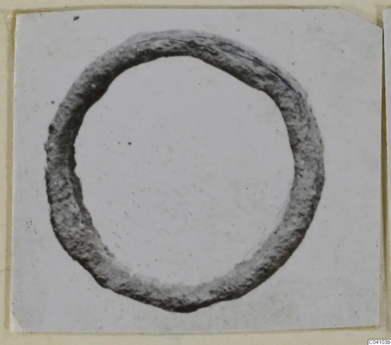 Corroded metal ring from Arsos, shown on a card mount.