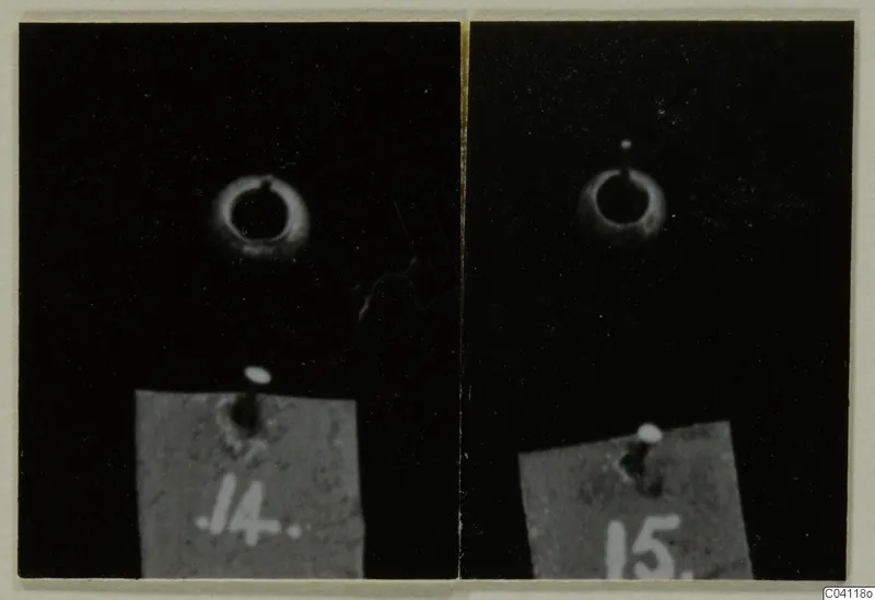 Two small gold rings with loops, each photographed on a black background beside a numbered card label