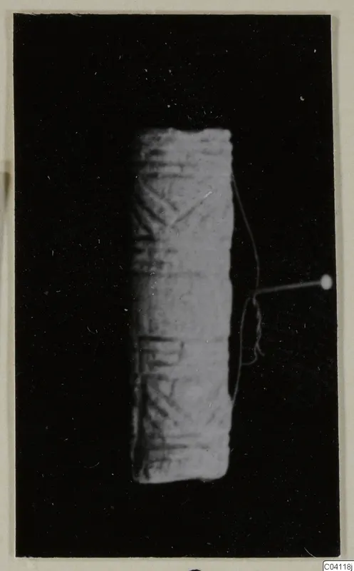 Cylindrical object with incised linear pattern, from Amathus, photographed against a black background