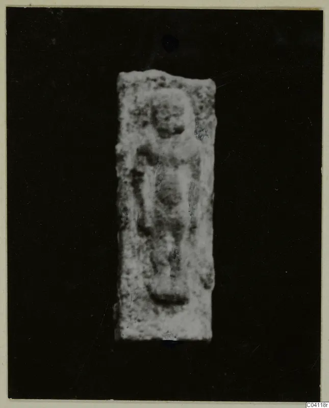 Rectangular plaque with a raised relief of a standing figure, photographed against a black background, from Vouni