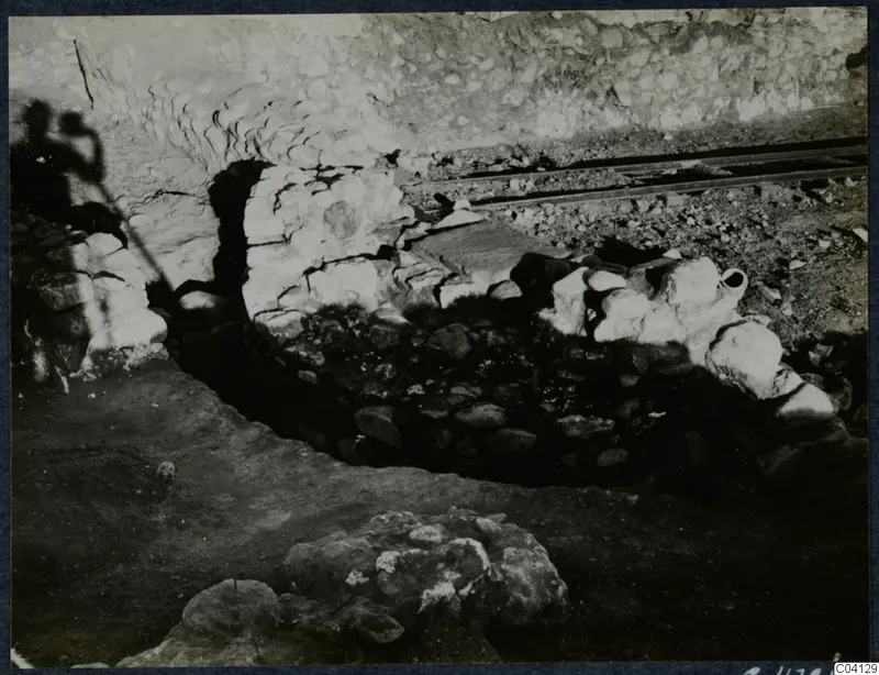 Excavation at Cholades, Soli, showing a stone wall beside a rail track