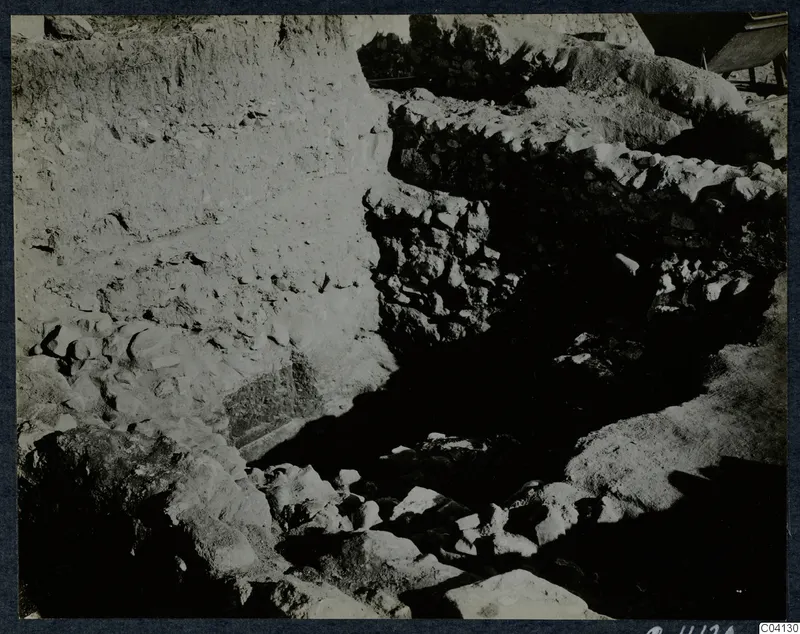 Excavation at Cholades, Soli, showing a stone-walled trench and a steep soil face
