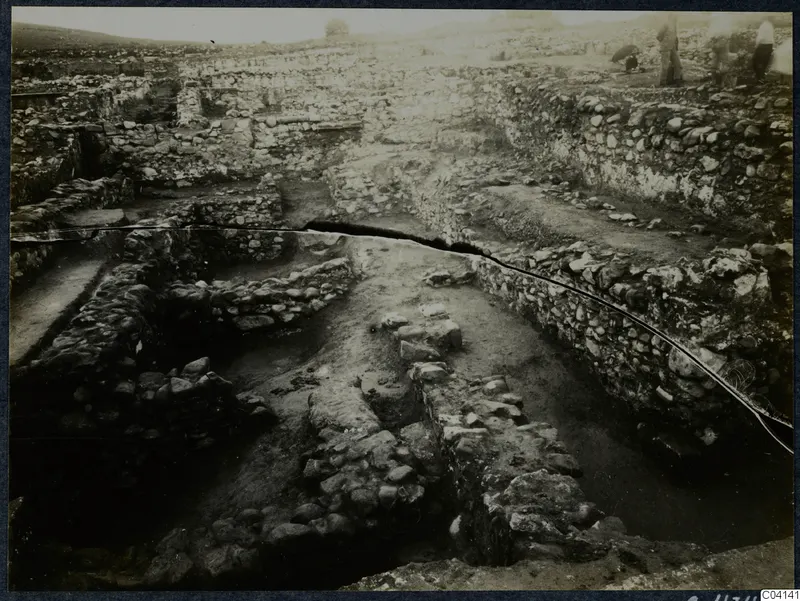Excavated stone walls at Soli, Cholades Temples C-F, with several people standing at the upper right edge