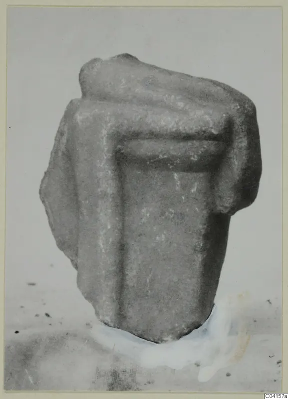 Fragment of a marble sculpture with a projecting upper part and a recessed panel in the centre.