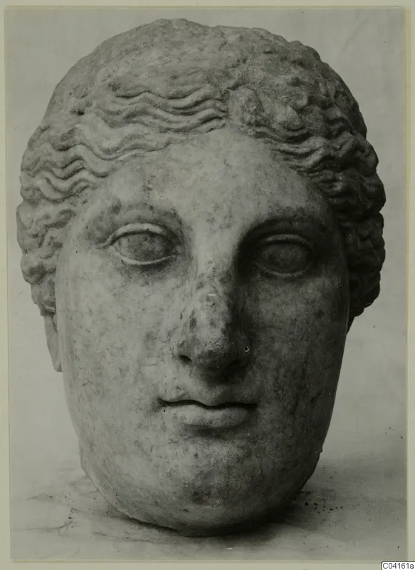 Marble head of a figure with wavy hair, seen from the front